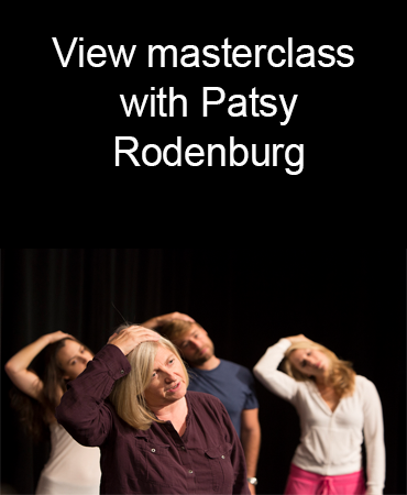 Patsy Rodenburg leads students in an exercising stretching their neck
